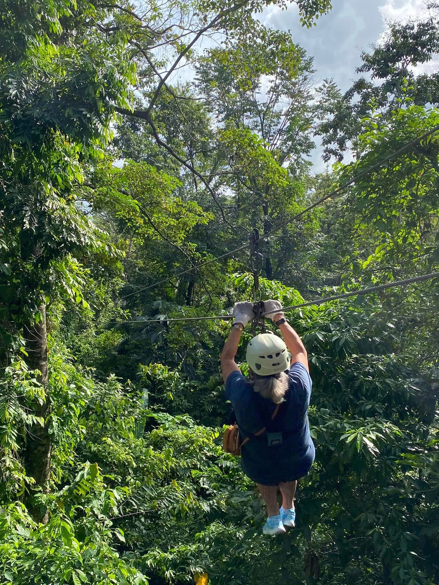 Zip lining through Costa Rica jungle canopy