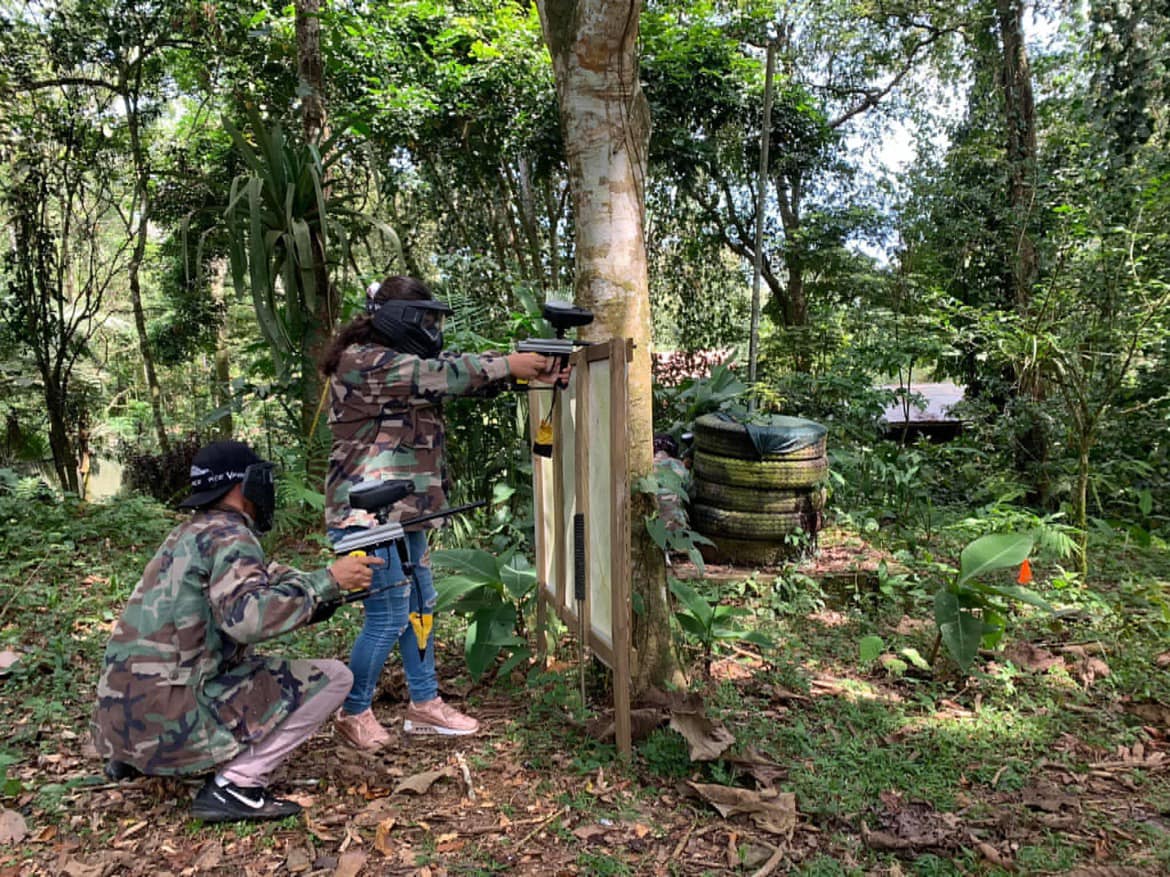 Paintball players in jungle arena