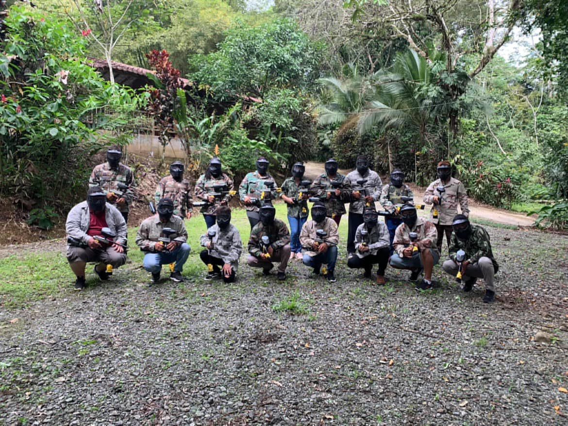 Paintball group in camouflage gear in jungle setting